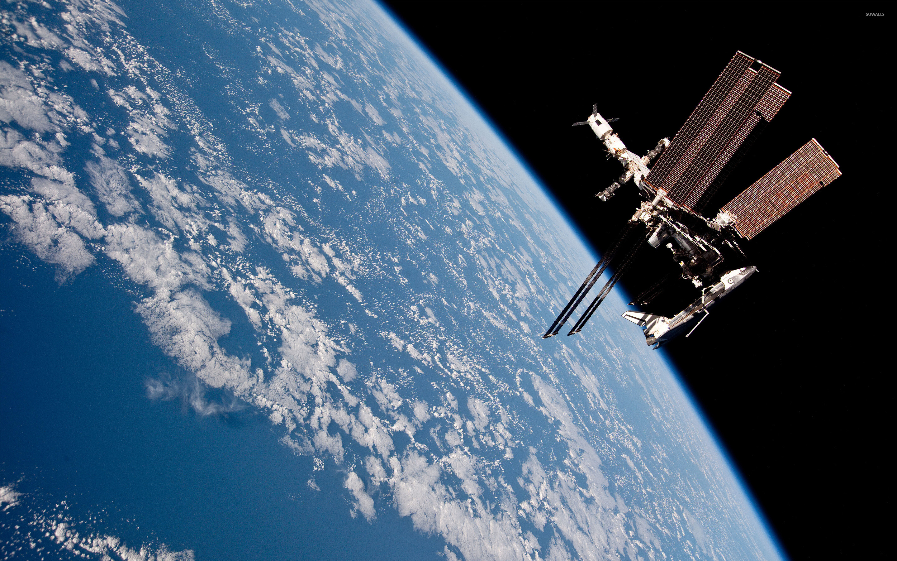 Space Station: An artificial satellite rely on solar panels to obtain power. 2880x1800 HD Background.
