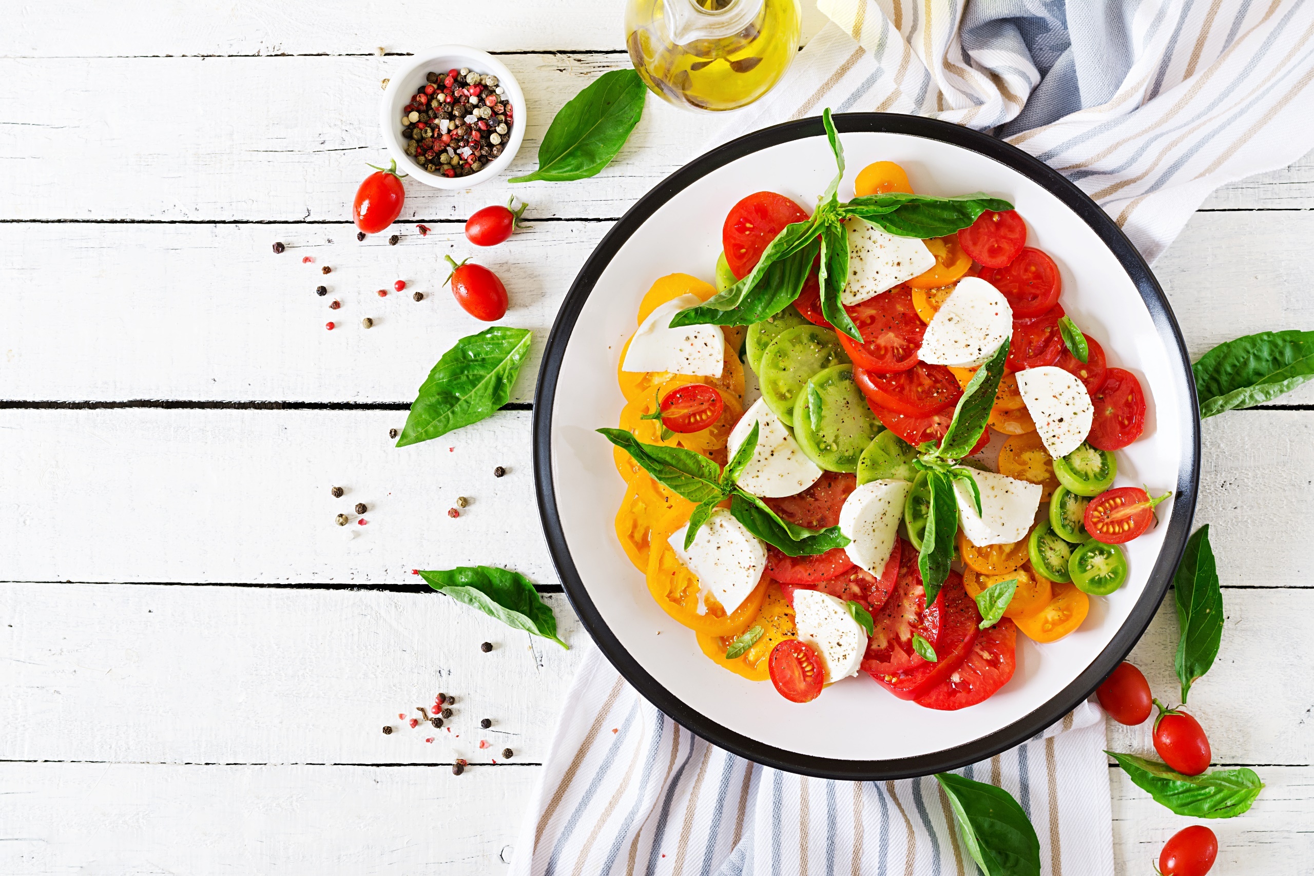 Salad garnished, Tomatoes and basil, Mozzarella and spice, Wooden surface, 2560x1710 HD Desktop