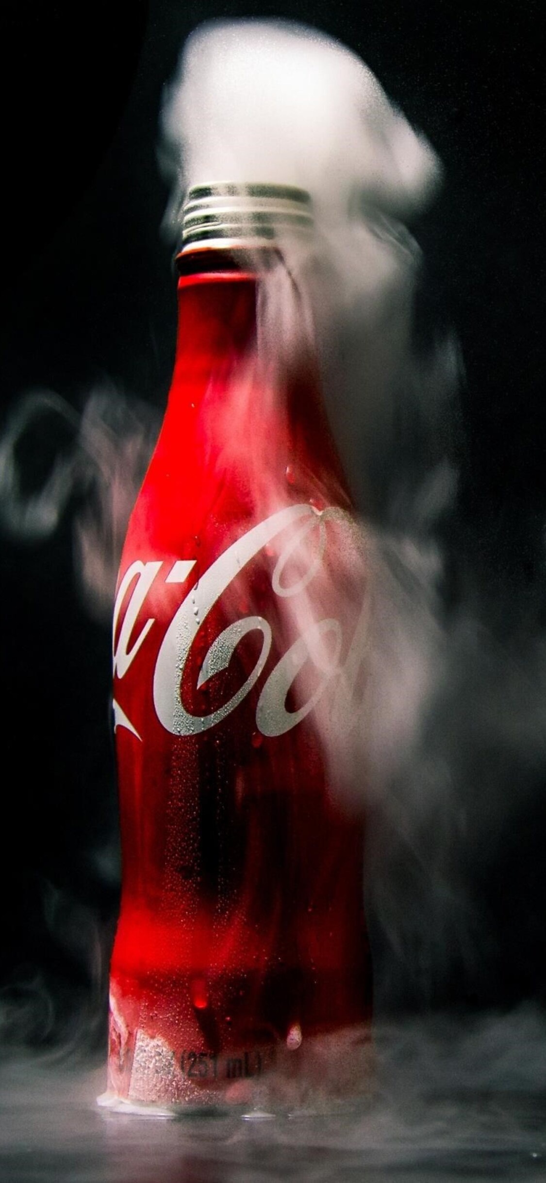 Coca-Cola: The exact formula of Coca-Cola's natural flavorings is a trade secret. 1130x2440 HD Background.