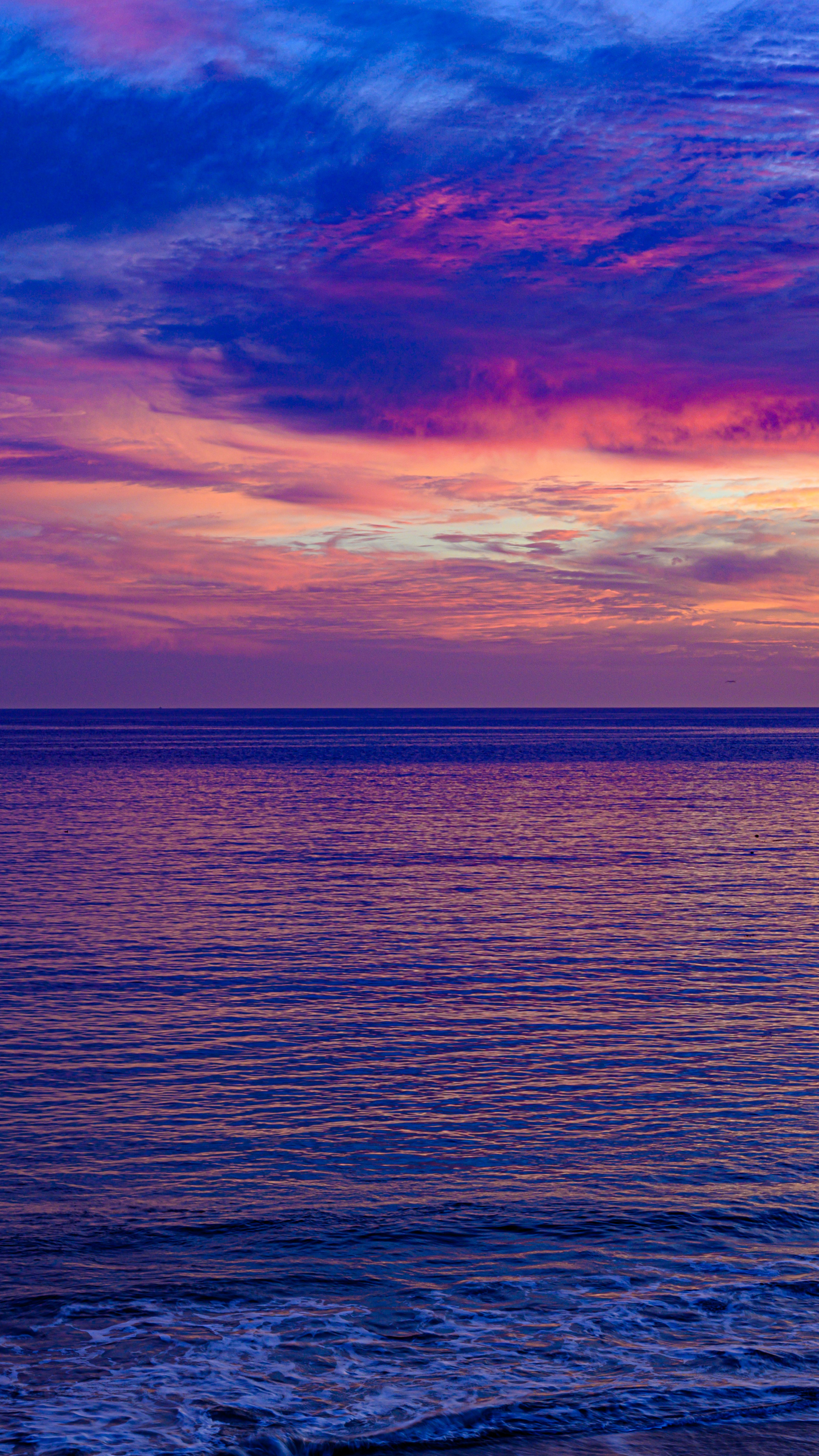 Seascape: The pink sunset view from the coast of the Adriatic sea, Croatia. 2160x3840 4K Background.