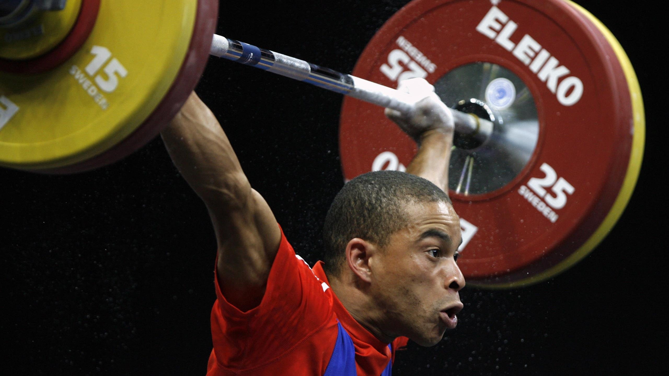 Weightlifting: The bar loaded with weights, Rio 2016 Olympic Games, Strength athletics. 2560x1440 HD Background.