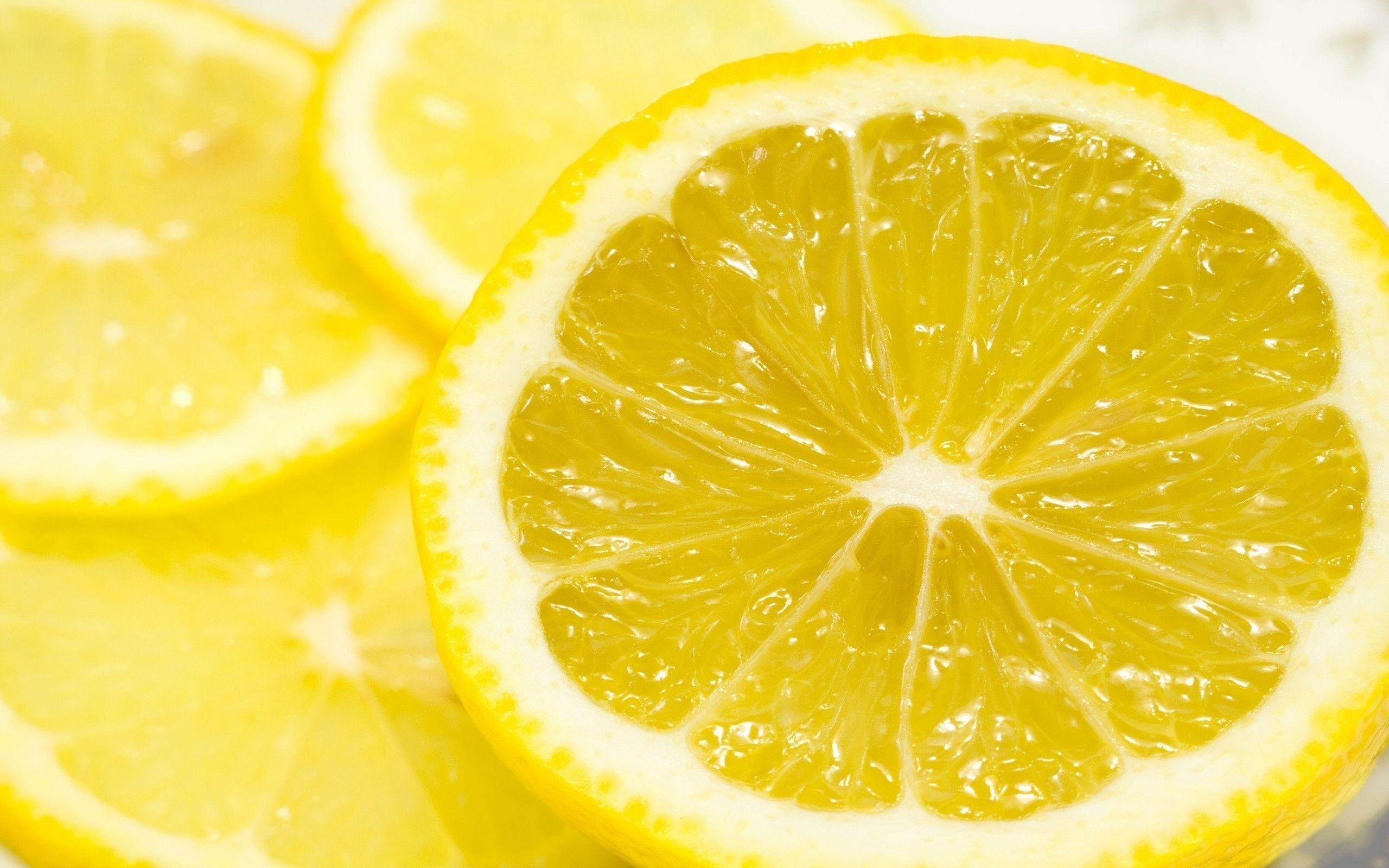Lemon: A small tree or spreading bush of the rue family Rutaceae. 2560x1600 HD Background.