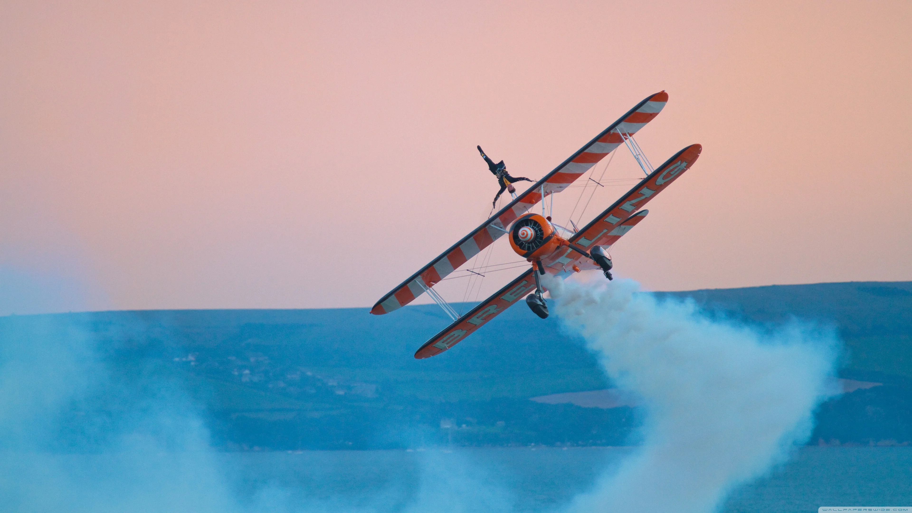 Aerobatics: Biplane aircraft, Extreme tricks by a pilot, Dangerous air sport. 3840x2160 4K Background.