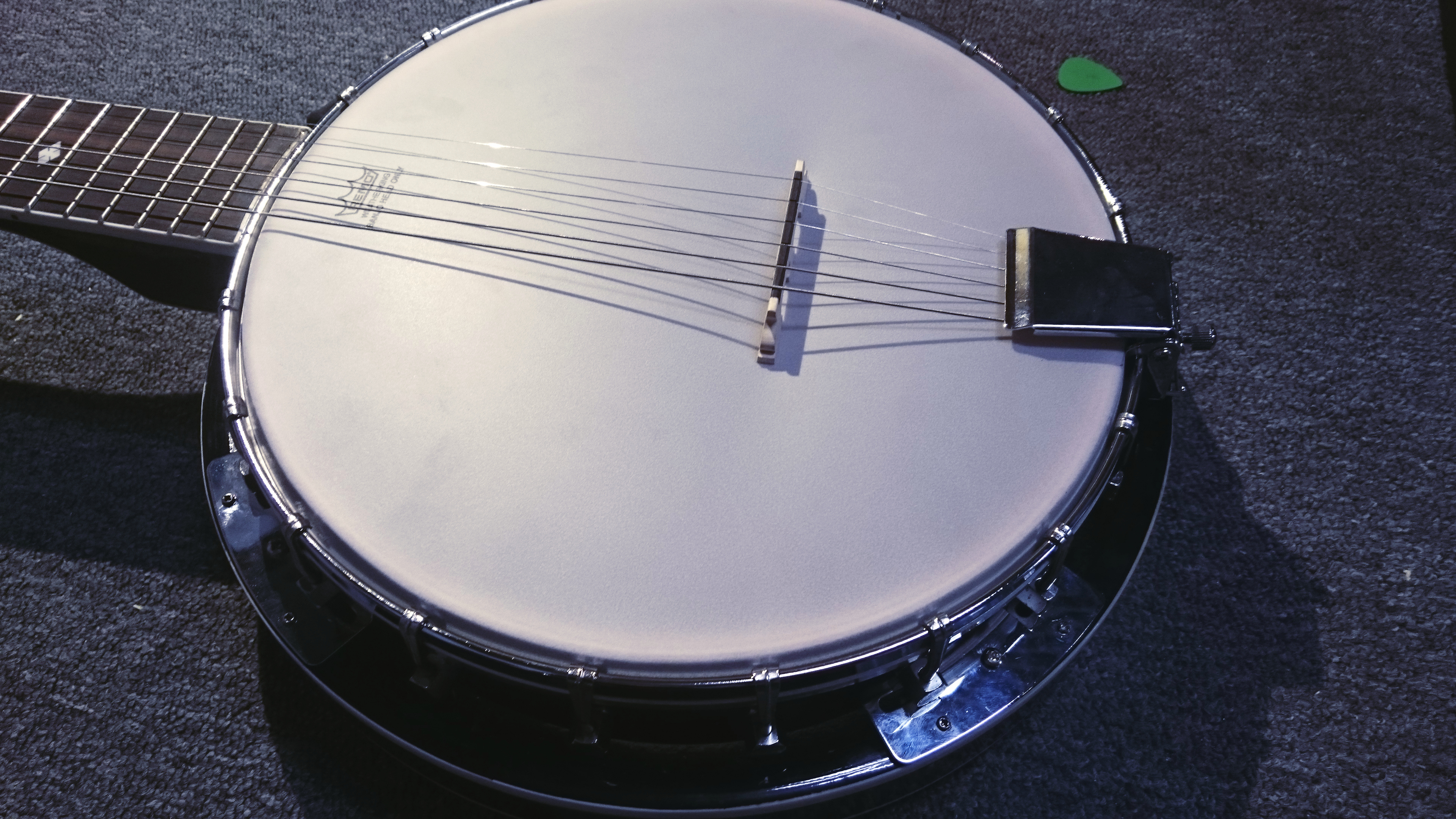 Banjo: An instrument with resonator body round-shaped deck in the form of a plastic diaphragm. 3840x2160 4K Background.