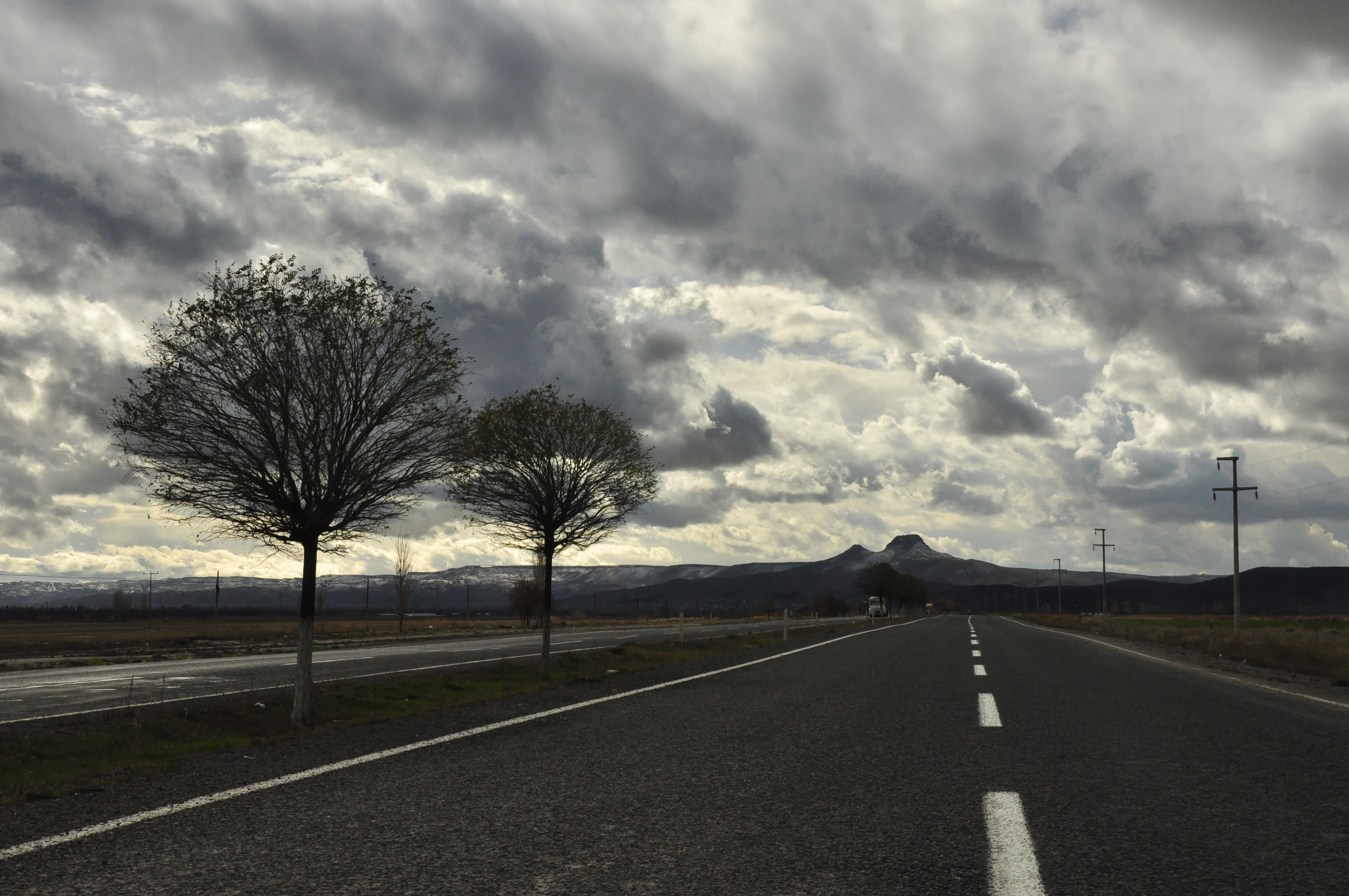 Gray Cloudy Sky: A slopping road, Grim weather, Darkening skies. 3220x2140 HD Background.