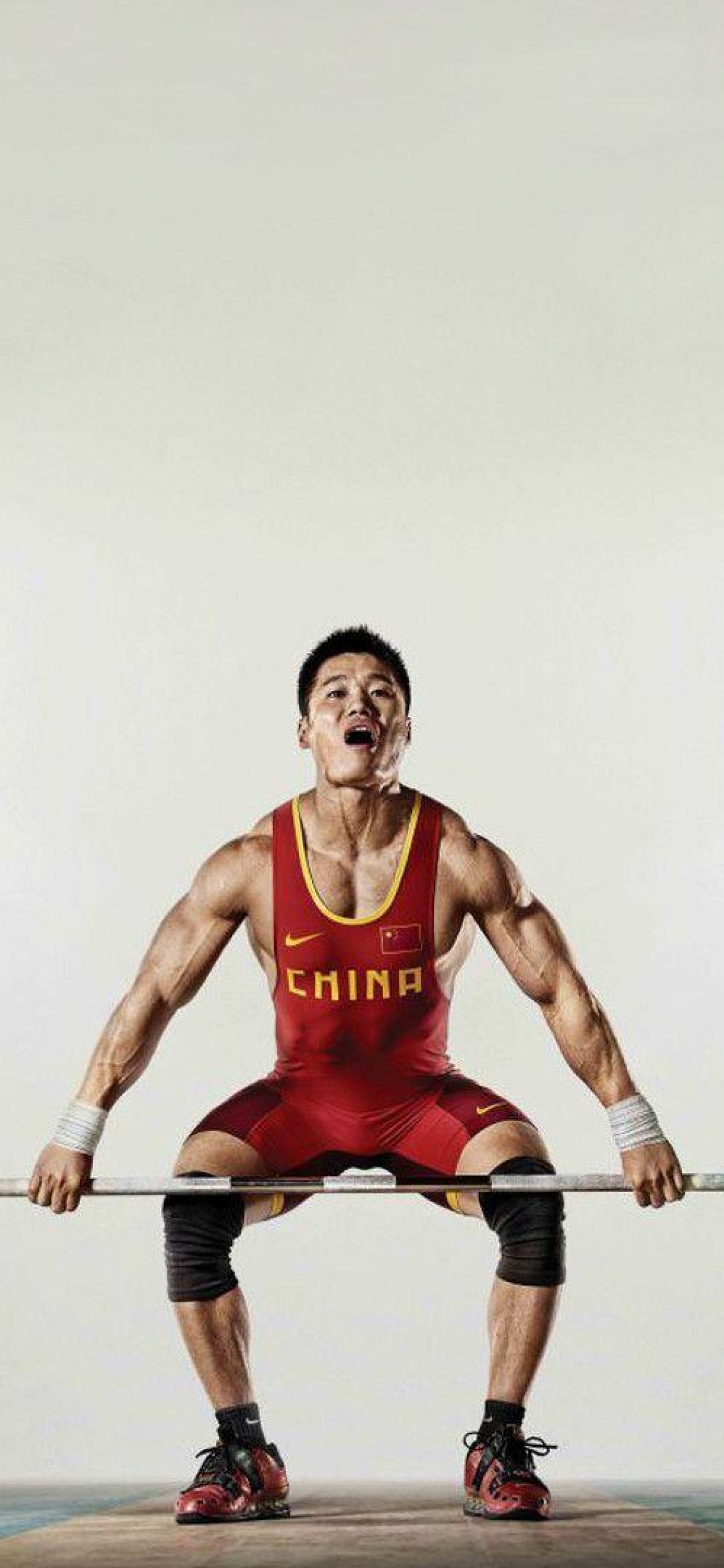 Weightlifting: A squatting position, Powerlifters, Weight training practice, Chinese athlete. 1170x2540 HD Wallpaper.