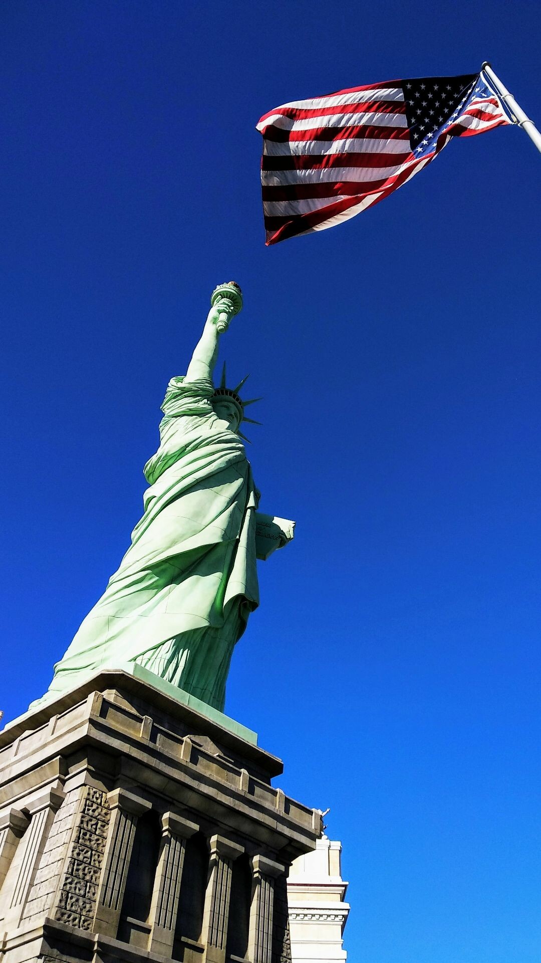 Statue of Liberty: The statue's crown bears seven spikes, symbolizing the seven oceans and seven continents of the world, and emphasizing her message of welcome, inclusiveness, and freedom. 1080x1920 Full HD Background.
