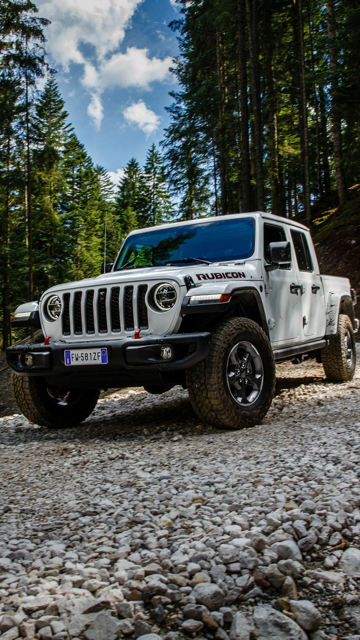 Jeep: A full-sized spare tire, normally mounted on the Wrangler's rear tailgate, is mounted underneath the cargo bed of the Gladiator. 1440x2560 HD Background.