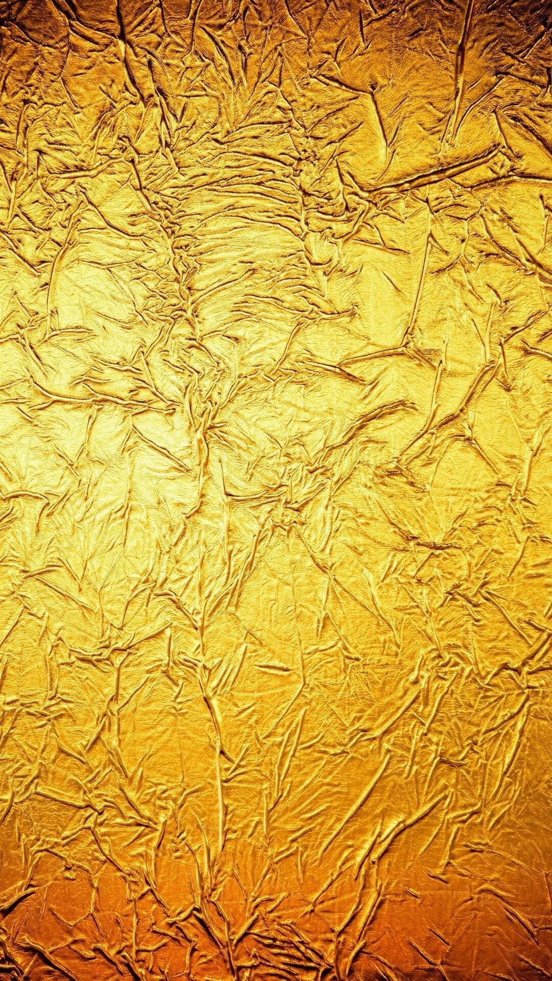 Gold Foil: Slightly reddish yellow metal that has been hammered into a thin sheet. 1080x1920 Full HD Background.
