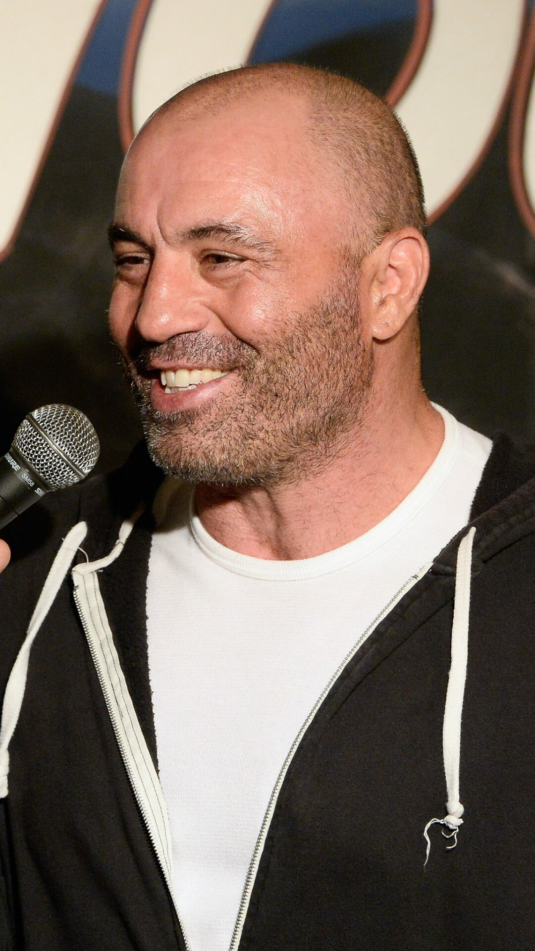 Joe Rogan: Secured a three-album deal with Warner Bros. Records in 1999. 1080x1920 Full HD Background.